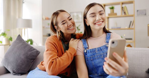 Selfie, smile and women or friends on sofa for social media, influencer content creation or digital memory and emoji face. Young, gen z people in profile picture, online photography and relax at home. - Foto, Imagem