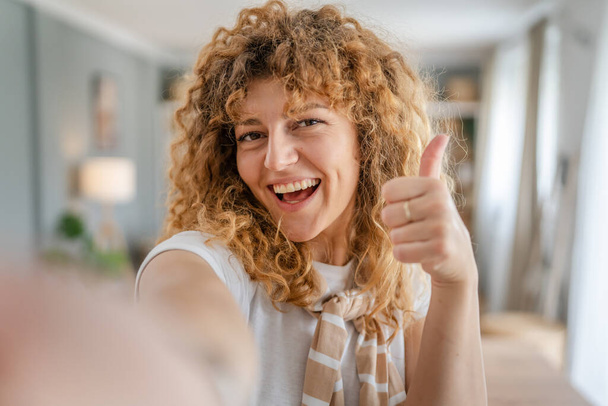 Portrait of one adult caucasian woman at home happy smile curly hair - Fotó, kép
