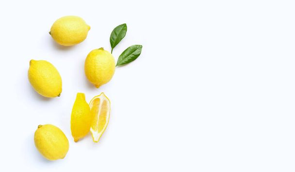 Fresh lemons with green leaves on white background. Copy space - Photo, Image
