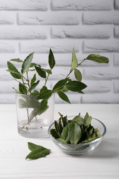 Fresh green bay leaves on white wooden table - Photo, Image