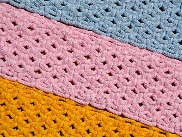 Macrame technique, a square knot of multi-colored threads. Colored macrame stripes in blue, yellow and pink colors. - Photo, Image