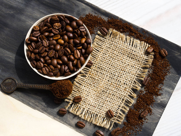 Coffee cone with ground coffee lie on coffee beans on burlap. Menu of coffee drinks. - Photo, Image