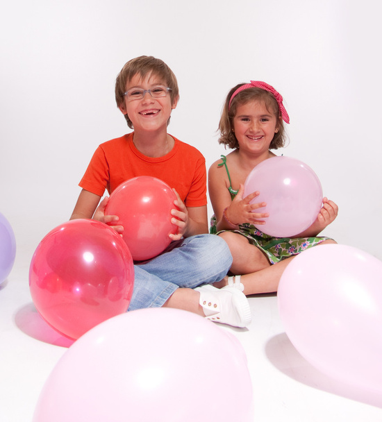 Boy and girl playing with balloons - Фото, зображення