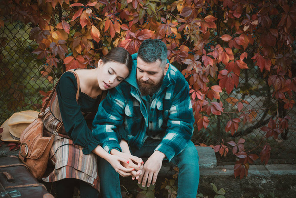 Attractive couple having a romantic moment together, dressing in traditional rural style sitting close to each other on an autumn day. The concept of genuine emotions. Meeting and accompany your - 写真・画像