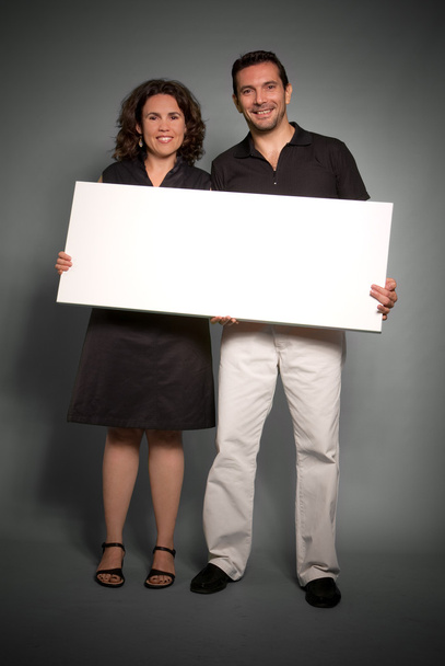 Cheerful couple holding a blank sign - Foto, Imagem