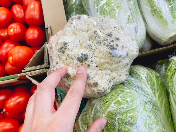 Spoiled cauliflower with mold in a hypermarket. Selective focus - Photo, Image