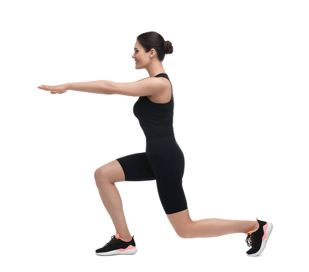 Happy woman doing morning exercise on white background - Foto, imagen