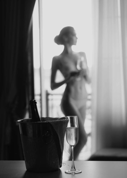 Elegant beautiful woman. Female slim model. Fashion photo with champagne. Sexy woman. Lingerie model - Foto, Imagen