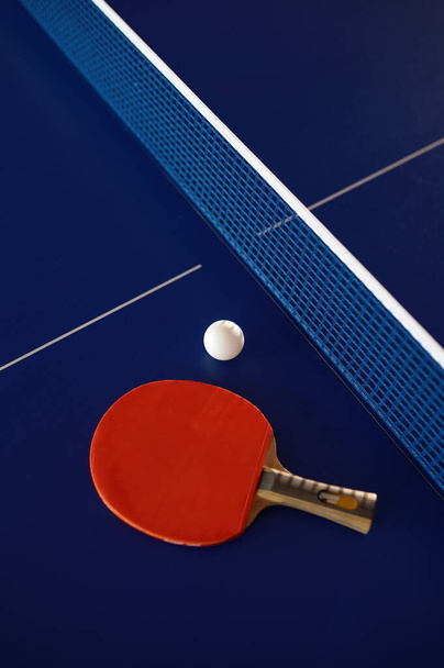 Table tennis equipment on blue ping pong table with grid net. Sport club and training class for skills improvement. Tennis still life - Φωτογραφία, εικόνα