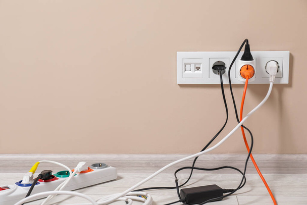 Extension cord with power plugs in sockets indoors, space for text - Фото, зображення