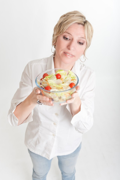 Woman looking at salad bowl - Photo, Image