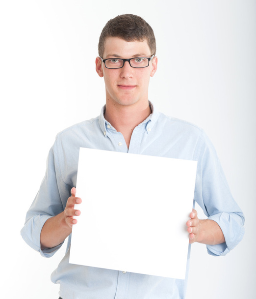 Young man holding a blank sign - Фото, зображення