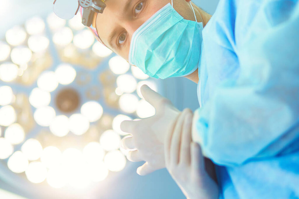 Male surgeon on background in operation room. - Φωτογραφία, εικόνα