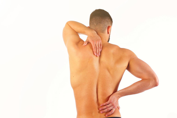 Young man holding his neck in pain. Medical concept. - 写真・画像