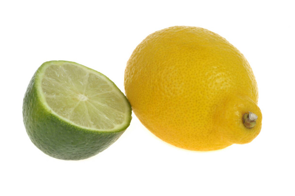 Whole yellow lemon and half lime close-up on white background  - Photo, Image