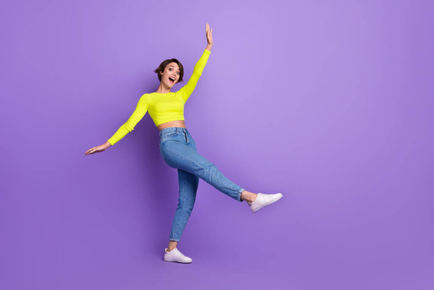 Full size portrait of carefree overjoyed girl have good mood dancing chilling isolated on purple color background. - 写真・画像