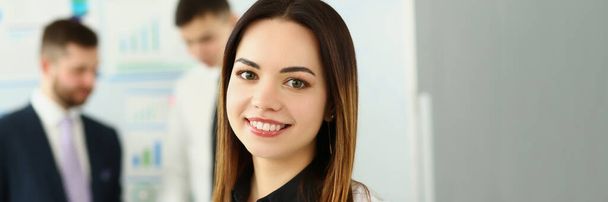 Portrait of smiling businesswoman in the background business partners. Successful career and internship in modern office - Photo, image