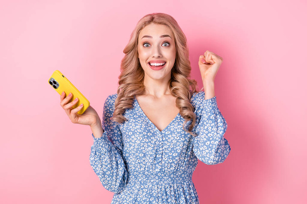 Photo of excited pretty girl raise fist success achievement hold smart phone like subscribe isolated on pink color background. - Fotoğraf, Görsel