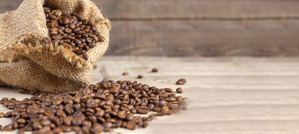 Fresh coffee beans in bags on a wooden background. Copy space. Banner - Photo, Image