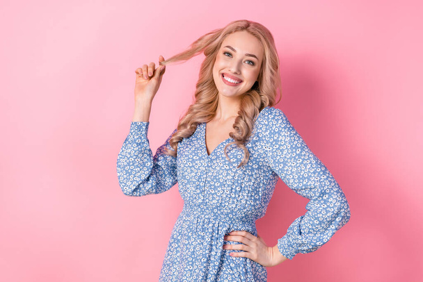 Photo of young charming girlish satisfied woman wear blue trendy dress lovely winsome cheery touch curls isolated on pink color background. - Valokuva, kuva