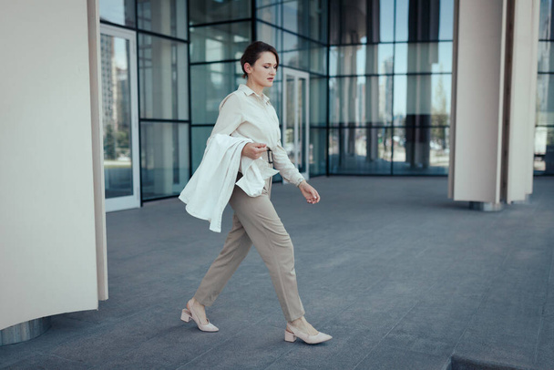 Active lifestyle of caucasian career business woman walking from work place office. - 写真・画像