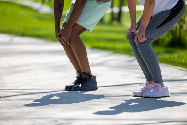 Active people. Couple exercising in the park and looking energetic - Photo, Image