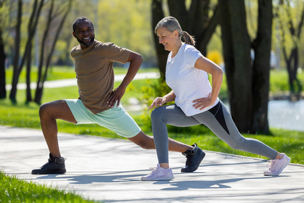 Outdoors workout. Mature couple having a workout together in the park - Fotografie, Obrázek