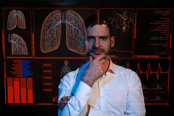 Caucasian bearded man looks at the medical screen of the respiratory system. HUD menu - 写真・画像