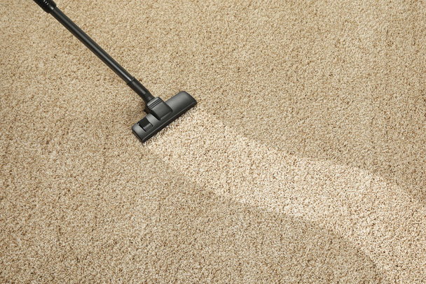 Hoovering carpet with vacuum cleaner, above view and space for text. Clean trace on dirty surface - Photo, Image