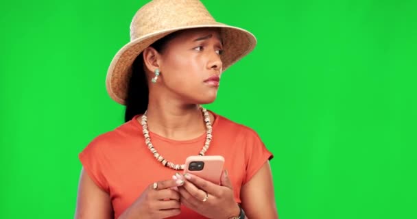 Green screen, lost and woman with a smartphone, searching for location and girl on a studio background. Female person, tourist and traveler with a cellphone, directions or maps with stress or anxiety. - Felvétel, videó