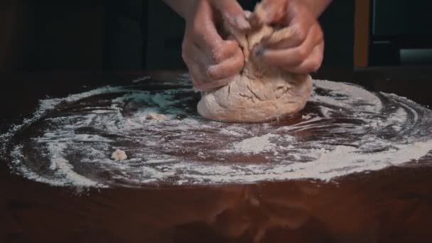 Kneading dough by female hands on the table close-up. Homemade flour cakes. Knead the sticky dough with your hands in Slow Mo Organic Fresh Bread. Baker bakes food at the bakery. - Footage, Video