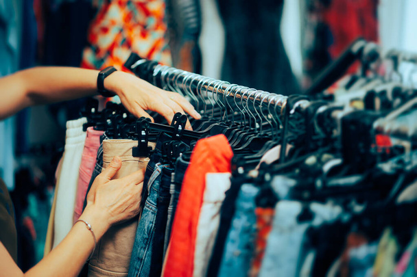 Hand of a Worker Arranging Clothes in a Fashion Store - 写真・画像
