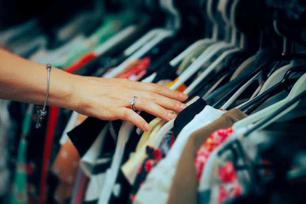 Hand of a Worker Arranging Clothes in a Fashion Store - Photo, Image
