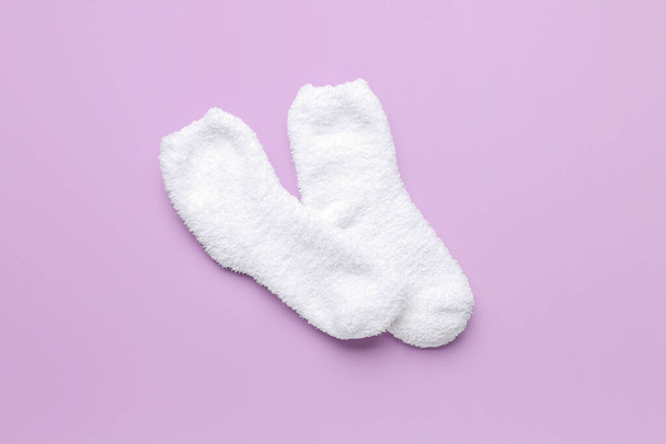 Pair of warm white socks on lilac background - Photo, Image