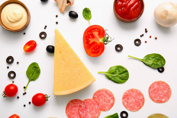 Fresh ingredients for preparing pizza on white background - Photo, Image
