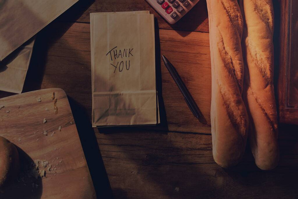 Chleb i wyposażenie piekarni na drewnianym stole - Zdjęcie, obraz