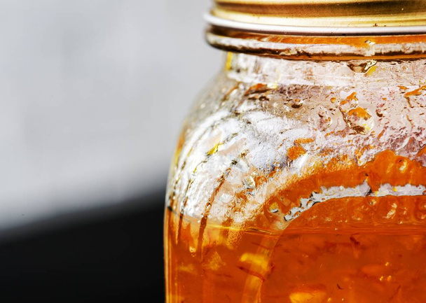 Closeup of marmalade in glass jar - Фото, зображення