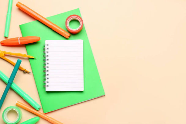 Notebooks with different stationery on pale orange background - Φωτογραφία, εικόνα