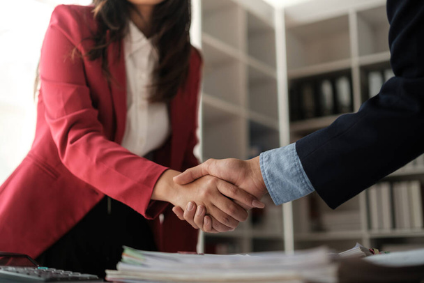 Handshake as successful negotiation ending, close-up. Unknown business people shaking hands after contract signing in modern office. High quality photo - Foto, immagini