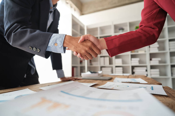 Handshake as successful negotiation ending, close-up. Unknown business people shaking hands after contract signing in modern office. High quality photo - Foto, Imagem