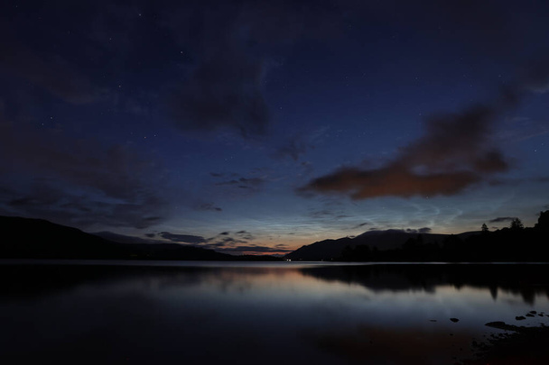 Noctilucent clouds over Derwentwater on the Summer Solstice near Keswick in the Lake District, Cumbria, United Kingdom, 20th June 2023 - Photo, Image