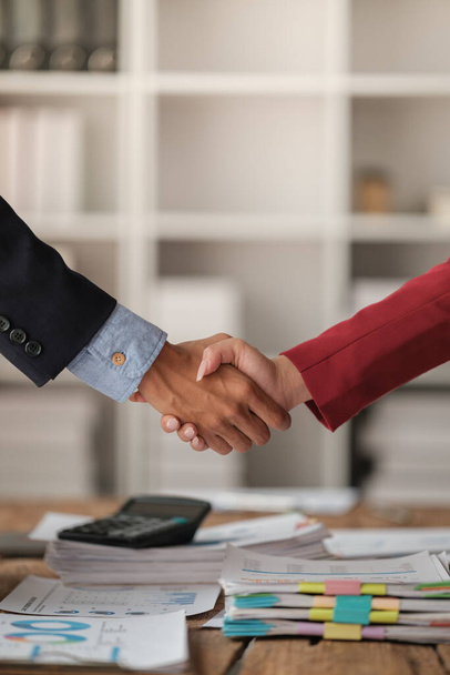 Handshake as successful negotiation ending, close-up. Unknown business people shaking hands after contract signing in modern office. High quality photo - Photo, Image