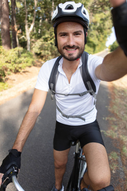 awesome selfie shot of happy man riding bicycle - Фото, изображение