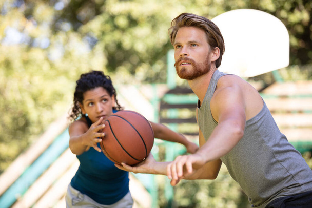 beautiful couple in love flirting and playing basketball - Photo, Image