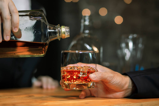 Bartender Serve Whiskey, on wood bar, - Fotó, kép