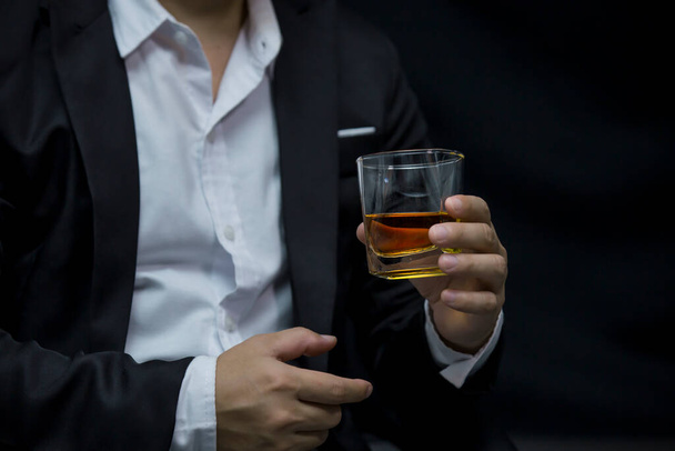 Closeup businessmen holding a glass of whiskey - Photo, image
