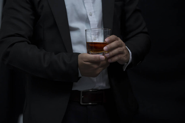 Closeup businessmen holding a glass of whiskey - Фото, изображение