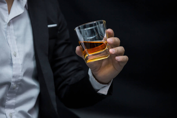 Closeup businessmen holding a glass of whiskey - Photo, Image
