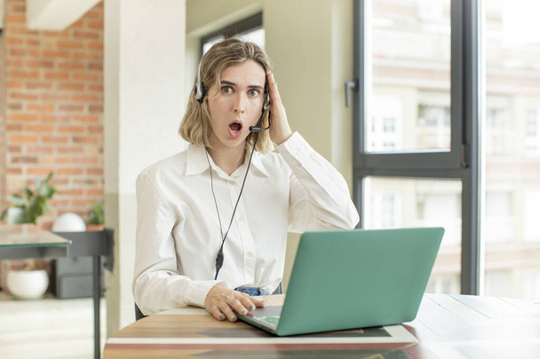 pretty woman feeling extremely shocked and surprised. telemarketer concept - Foto, Bild