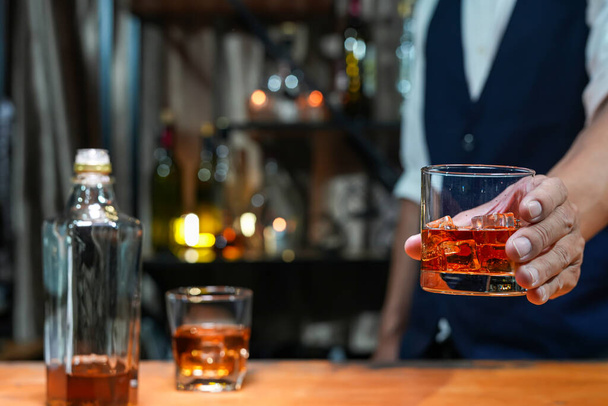 Bartender Serve Whiskey, on wood bar,  - Фото, изображение